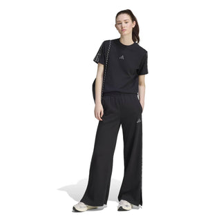 Women’s black track pants with animal-print side stripes and relaxed wide fit