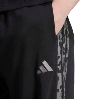 Black track pants with animal-print side stripe and adidas logo detail
