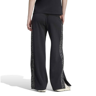 Women’s black track pants with animal-print side stripe, shown from behind