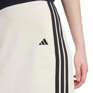 Off-white skirt detail with black triple stripe panel and small logo