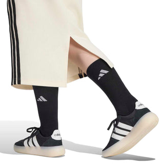Off-white skirt hem with black side stripes and center slit