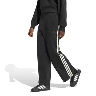 Women's black track pants with off-white 3-stripe side design, relaxed fit