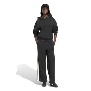 Women's black wide-leg track pants with off-white 3-stripe sides and drawcord waist