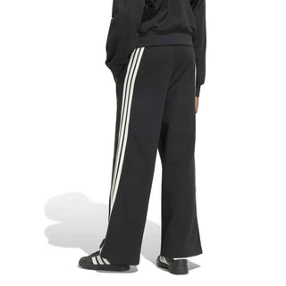 Women's black track pants with off-white 3-stripe side detail and relaxed fit