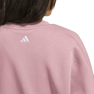 Women’s mauve sweatshirt close-up of small ADIDAS logo on upper back
