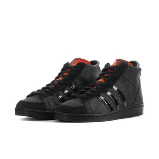 Men's black high-top sneakers with orange laces and glossy three-stripe details