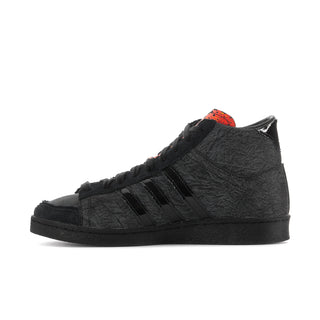 Men's black high-top sneakers with orange-spotted collar and three black stripes