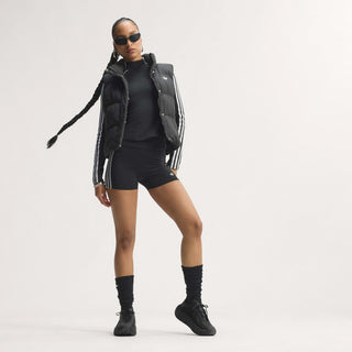 Men's black sneakers on a standing model, mesh sides and low-profile sole