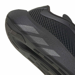 Close-up of men's black sneaker outsole edge with vented side tread