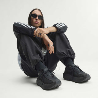 Men's black sneakers on a seated model, knit upper and low-profile sole