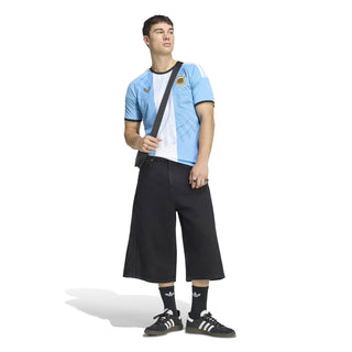 Light blue and white striped soccer jersey with black trim, worn with shorts