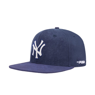 Navy Yankees strapback cap with side NY logo and small P-R-A-D mark