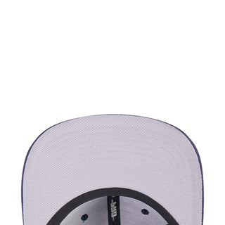 Two-tone cap top view with light crown and black-edged circular logo detail