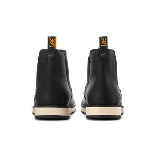 Men's black Chelsea boots with heel pull tabs, elastic gussets, and beige outsole trim.