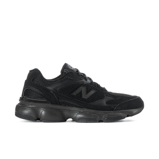 Black athletic sneaker with mesh upper, lace-up, and thick cushioned sole