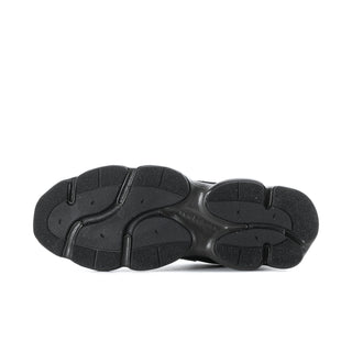 Black athletic sneaker outsole, textured tread bottom view