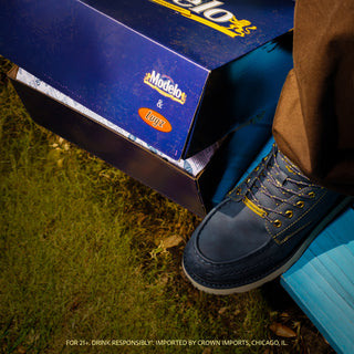 Men's navy lace-up boots with gold laces and beige sole, embossed toe detail