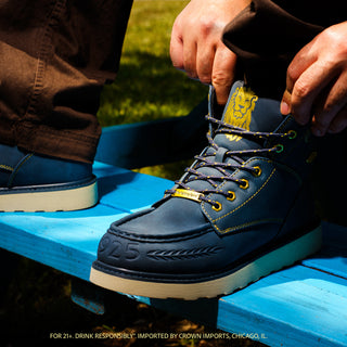 Men's navy lace-up boots with gold laces and yellow logo on the tongue
