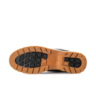 Gum rubber boot outsole with chunky tread pattern and black traction inserts