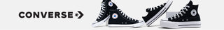Black Converse sneakers with white soles on a white background