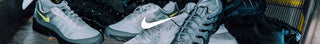 Gray sneakers with a Nike logo on a dark background
