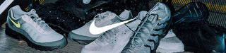 Gray sneakers with a Nike logo on a dark background