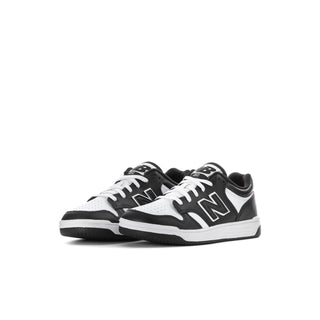 Kids' New Balance sneakers, black and white, side view with large N logo