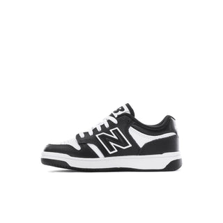 Kids' New Balance sneakers, black and white, front three-quarter view