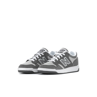Kids New Balance sneakers, angled side view with gray uppers and white trim