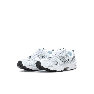Kids' New Balance 530 sneakers, side view in white with navy accents