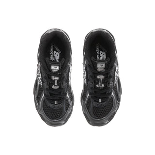Kids black sneaker top view with open tongue, lace-up laces, and inner lining