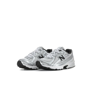 Pair of kids silver metallic running shoes with black accents and lace-up design