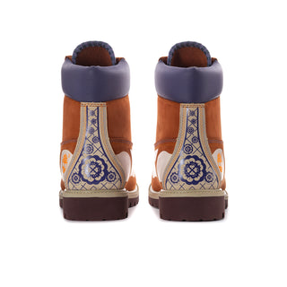 Men's brown lace-up boots with indigo heel lining and blue patterned side panels.