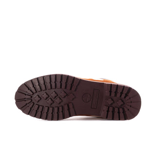 Boot outsole with deep tread grooves in dark rubber, showing rugged traction pattern.