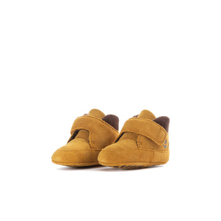 Pair of infant wheat crib booties with hook-strap and dark brown cuff lining