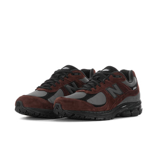 Men's sneakers, side view, dark brown suede panels with black laces and gray accents