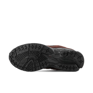 Men's sneakers outsole, black textured tread with dark brown upper edge