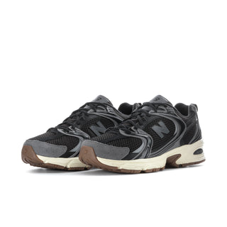 Black mesh athletic sneakers with gray overlays, N logo, beige midsole, gum outsole