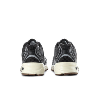 Black mesh sneakers with beige heel panel, cushioned collar, rear branding detail