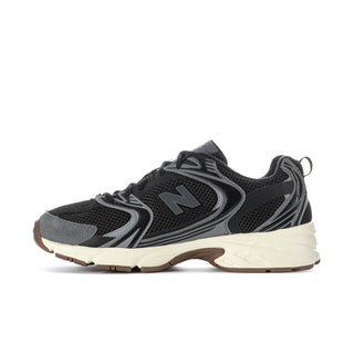 Black mesh sneakers with gray overlays, large N logo, light beige midsole, gum accents