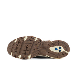 Brown rubber outsole with tread pattern, white/cream midsole, side blue logo