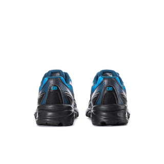 Men's New Balance sneakers from heel view, blue uppers with black heel and sole.