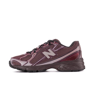 Women’s running shoes, angled side view: burgundy mesh with white N and black trim