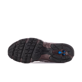 Women’s running shoes outsole view: dark tread with burgundy sidewall and blue accent