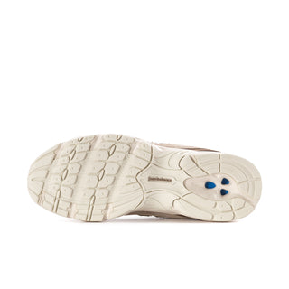Women's sneaker outsole in off-white with traction grooves and blue logo accent.