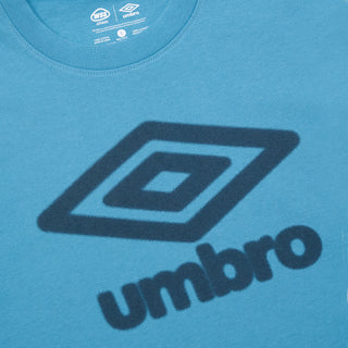 Turquoise blue athletic tee close-up with Umbro logo and small neck label