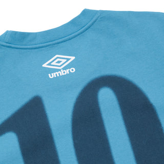 Turquoise blue athletic tee close-up of back "10" print with Umbro chest logo