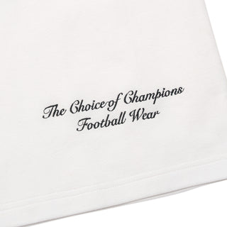 White polo shirt hem with 'The Choice of Champions' printed text