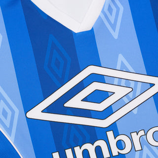 Umbro logo and fabric pattern close-up on blue jersey panel