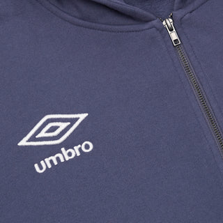 Close-up of dark blue hoodie fabric with Umbro logo on left chest